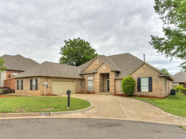 view of front of property with driveway, a front yard, roof with shingles, brick siding, and an attached garage