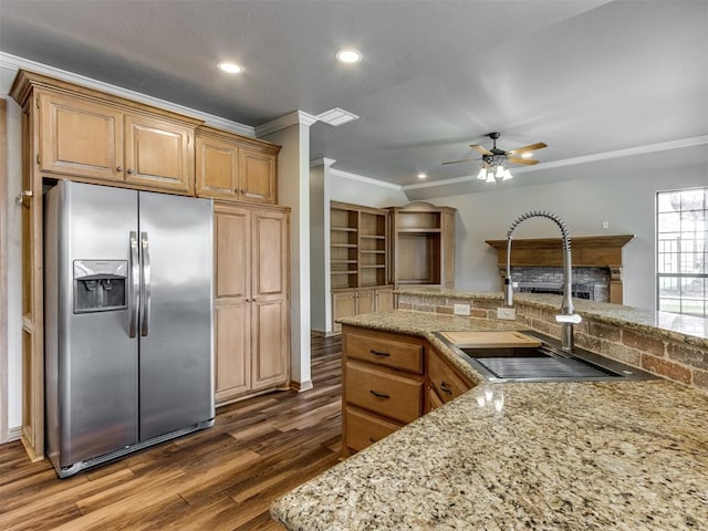 kitchen featuring a ceiling fan, ornamental molding, stainless steel refrigerator with ice dispenser, dark wood-type flooring, and a sink