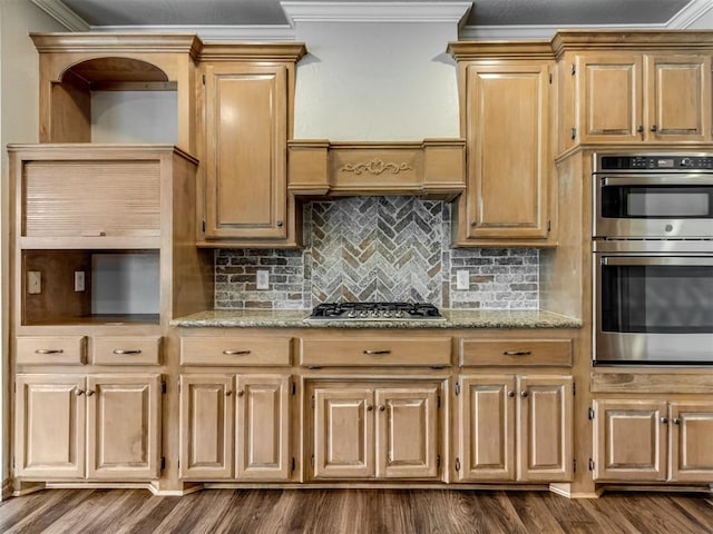 kitchen featuring crown molding, dark wood finished floors, appliances with stainless steel finishes, and backsplash