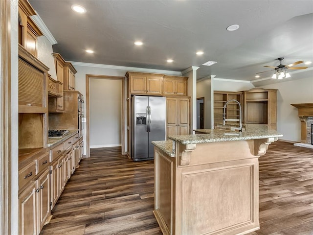 kitchen with appliances with stainless steel finishes, baseboards, dark wood-style flooring, and ceiling fan