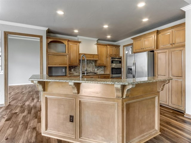kitchen with dark wood-style flooring, stainless steel appliances, light stone counters, and a kitchen breakfast bar
