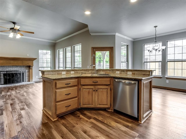 kitchen with stainless steel dishwasher, crown molding, dark wood-style floors, and a sink