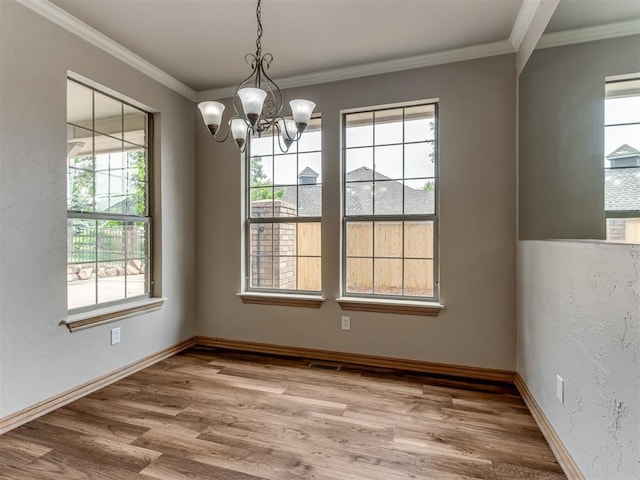 unfurnished dining area with a notable chandelier, wood finished floors, and a wealth of natural light