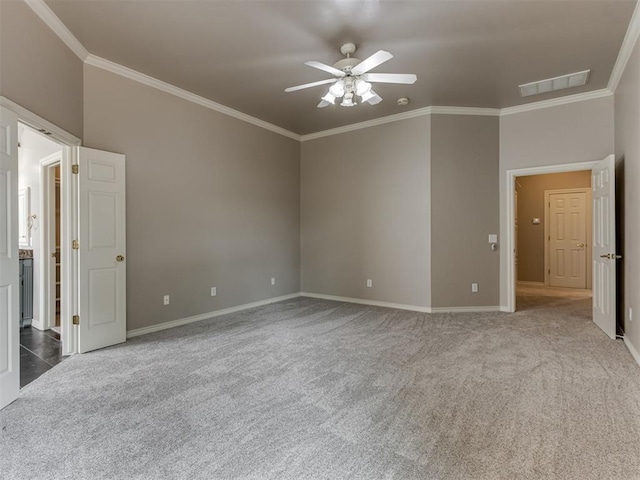 unfurnished bedroom with carpet floors, ornamental molding, and visible vents
