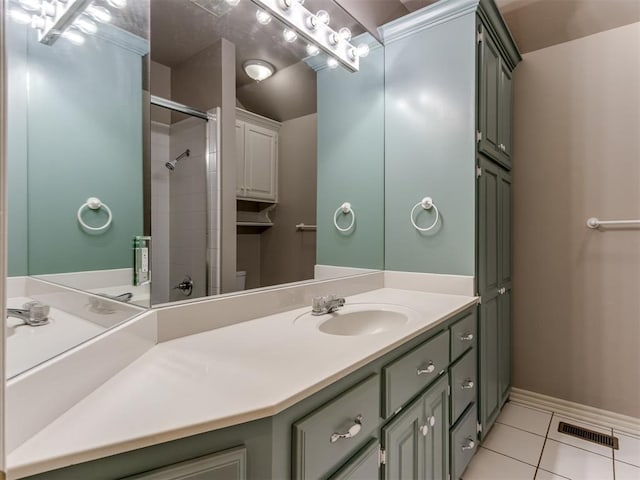 full bath with tile patterned flooring, vanity, baseboards, a shower, and visible vents
