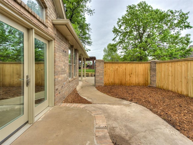 view of yard featuring fence and a patio