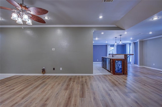 kitchen with crown molding, baseboards, ceiling fan, and light wood finished floors