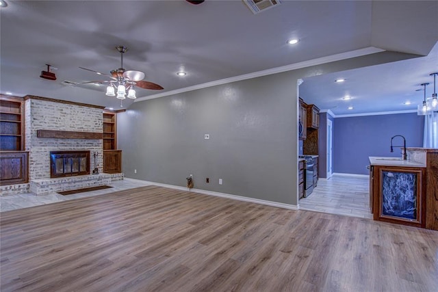 unfurnished living room featuring ceiling fan, recessed lighting, baseboards, visible vents, and ornamental molding