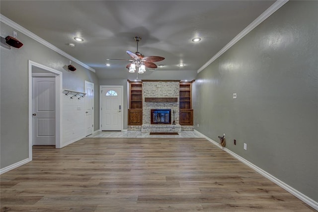unfurnished living room with crown molding, baseboards, and a ceiling fan