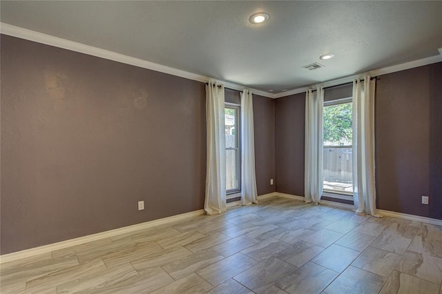 spare room featuring recessed lighting, baseboards, visible vents, and ornamental molding
