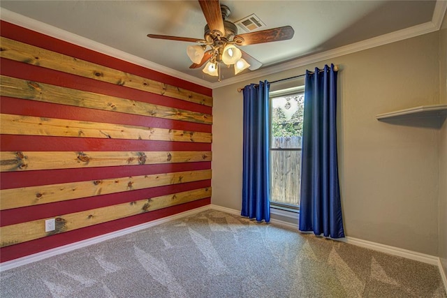 empty room with carpet floors, baseboards, ceiling fan, and visible vents