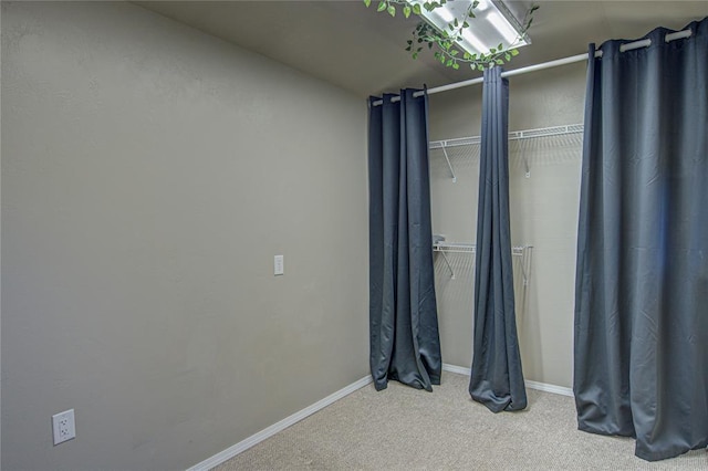 unfurnished bedroom featuring baseboards and carpet flooring
