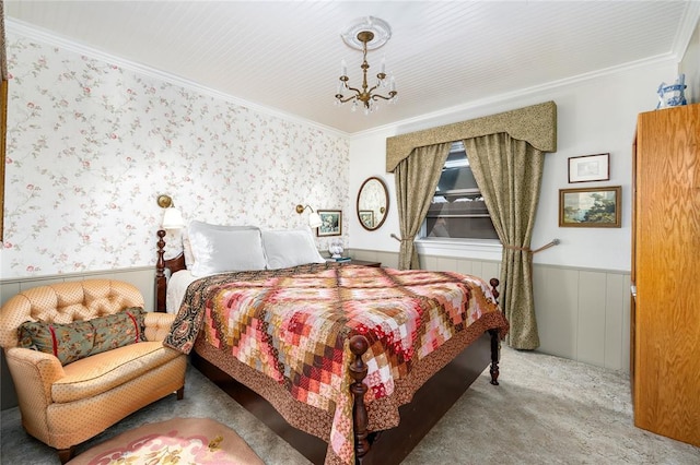 bedroom featuring crown molding, wainscoting, and carpet floors
