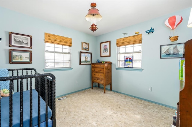 bedroom with visible vents, baseboards, carpet floors, and multiple windows