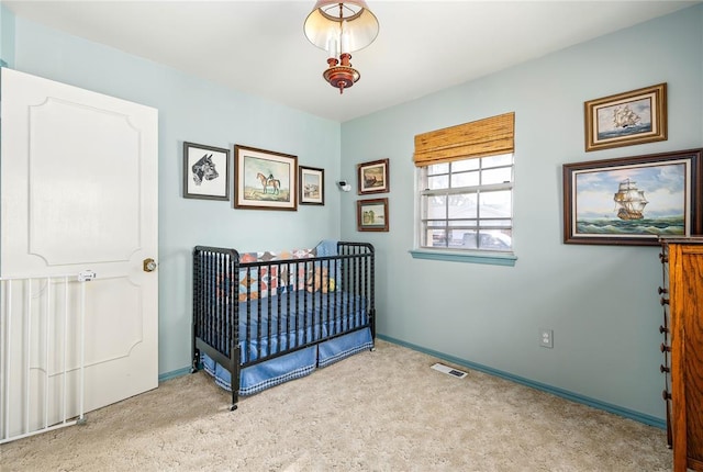 bedroom with carpet floors, baseboards, and visible vents