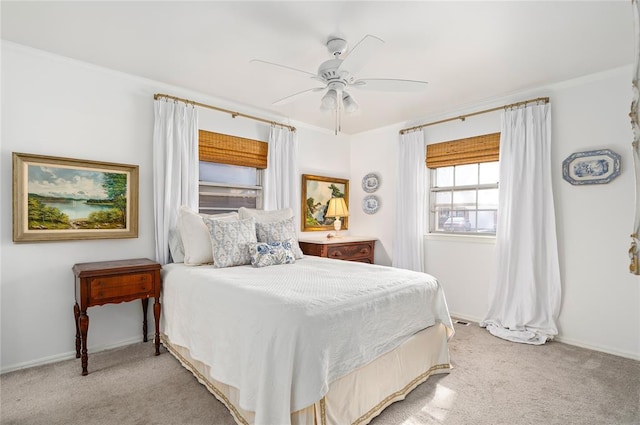 bedroom featuring a ceiling fan, baseboards, light carpet, and ornamental molding