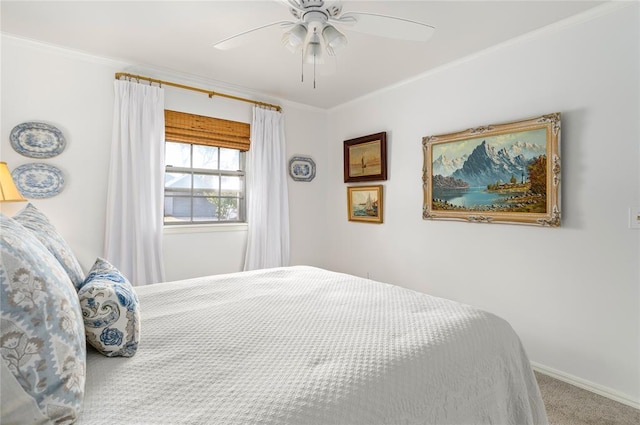 carpeted bedroom with crown molding, baseboards, and a ceiling fan