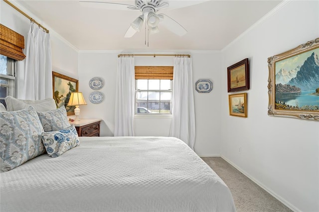 carpeted bedroom with crown molding, baseboards, and ceiling fan