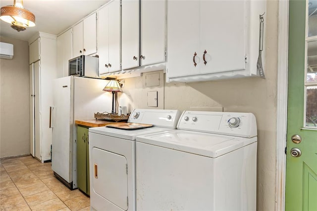 laundry room with an AC wall unit, cabinet space, and washer and dryer