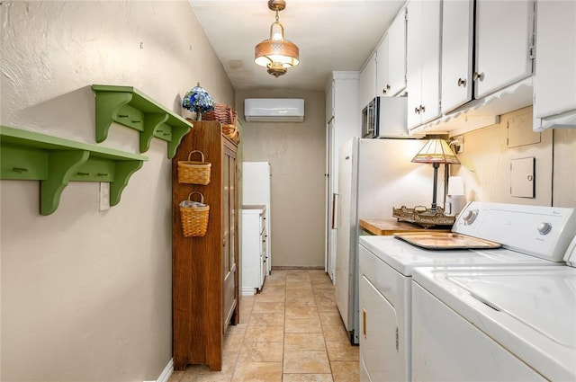 washroom featuring laundry area, stone finish flooring, washing machine and clothes dryer, a wall mounted air conditioner, and baseboards