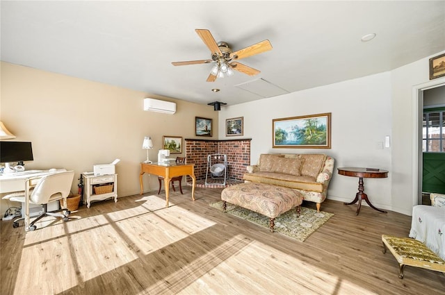 living area with baseboards, a wall mounted air conditioner, ceiling fan, and wood finished floors