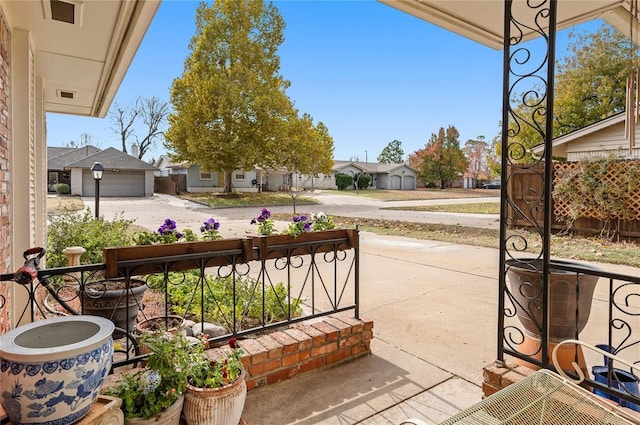 view of patio / terrace with a residential view and covered porch