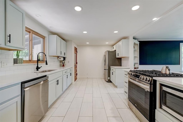 kitchen featuring backsplash, appliances with stainless steel finishes, a sink, and light countertops