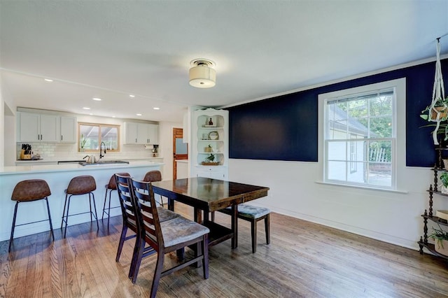 dining area featuring recessed lighting, baseboards, wood finished floors, and a wealth of natural light
