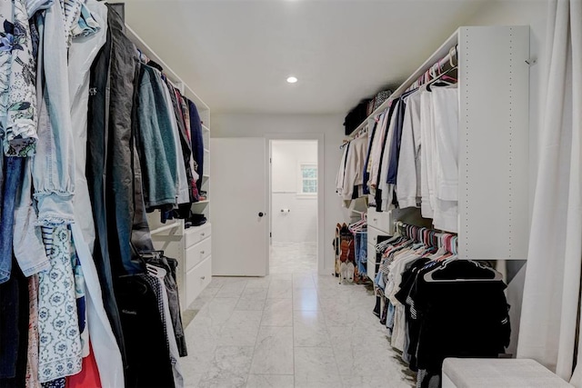 spacious closet featuring marble finish floor