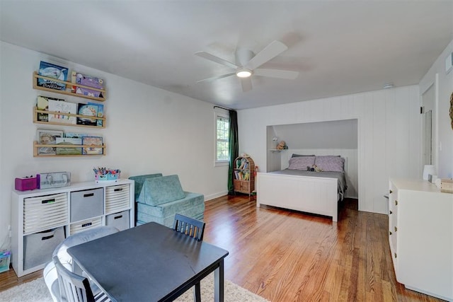 bedroom with a ceiling fan and light wood-style flooring