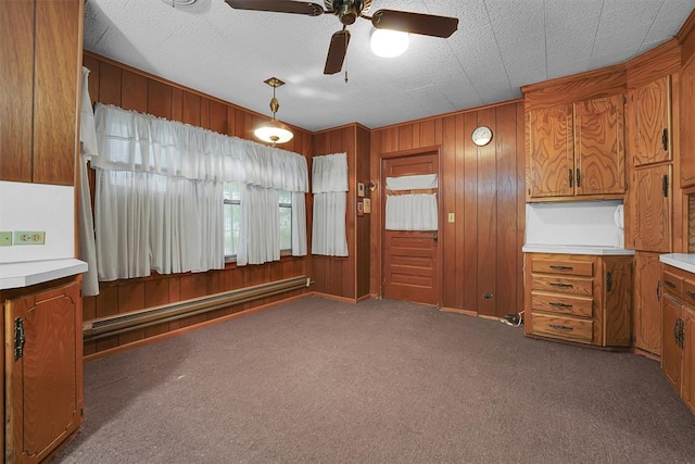 interior space featuring ceiling fan, a baseboard heating unit, and wooden walls
