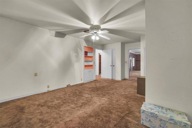 empty room featuring carpet flooring, a ceiling fan, and baseboards