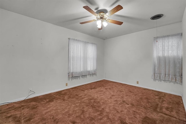carpeted spare room featuring plenty of natural light and baseboards