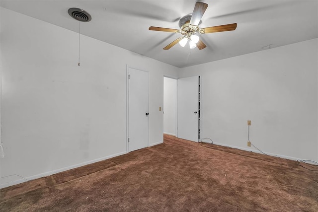 carpeted empty room featuring visible vents, baseboards, and ceiling fan