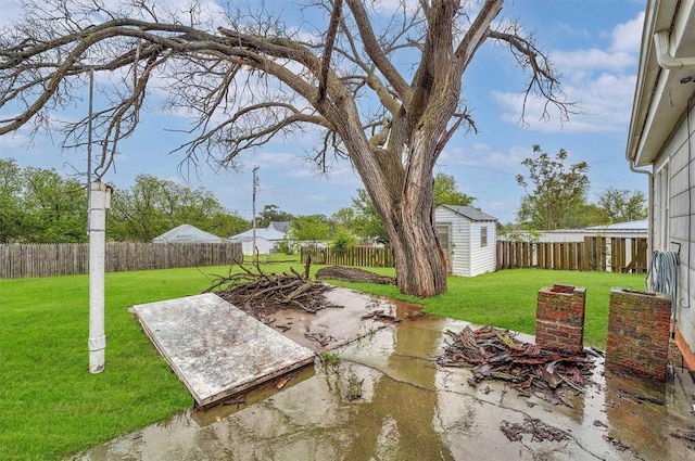 view of patio / terrace featuring an outdoor structure, a fenced backyard, and a storage unit