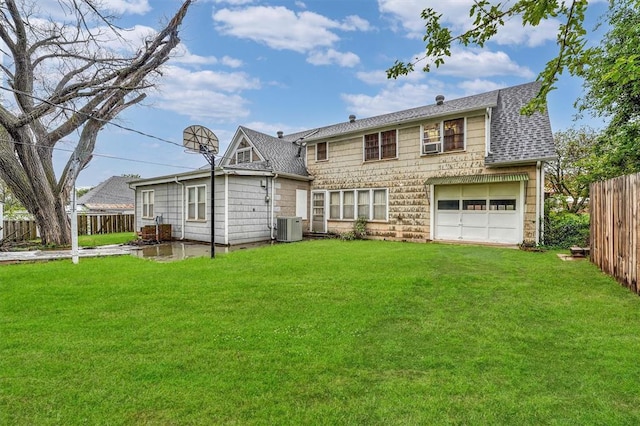 exterior space featuring fence, central AC unit, and a front lawn
