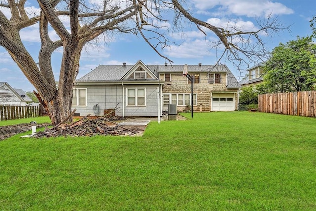 back of house featuring central air condition unit, a lawn, and fence