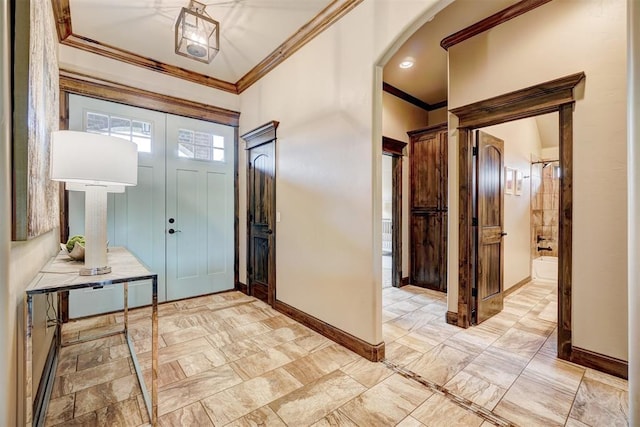 entrance foyer featuring arched walkways, ornamental molding, baseboards, and marble finish floor