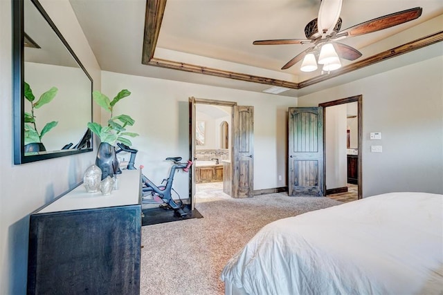 carpeted bedroom featuring connected bathroom, ceiling fan, visible vents, and a raised ceiling