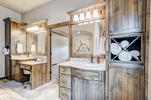 bathroom featuring two vanities and a sink