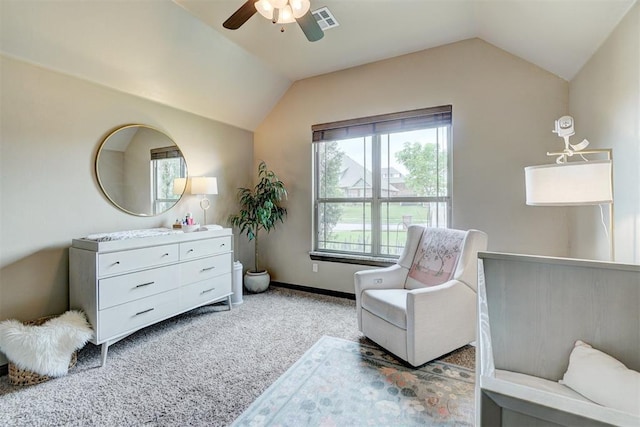 living area with a ceiling fan, light colored carpet, visible vents, baseboards, and lofted ceiling