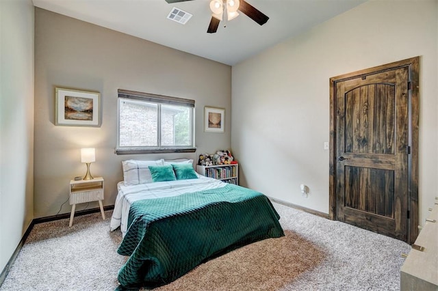 carpeted bedroom featuring baseboards, a ceiling fan, and visible vents