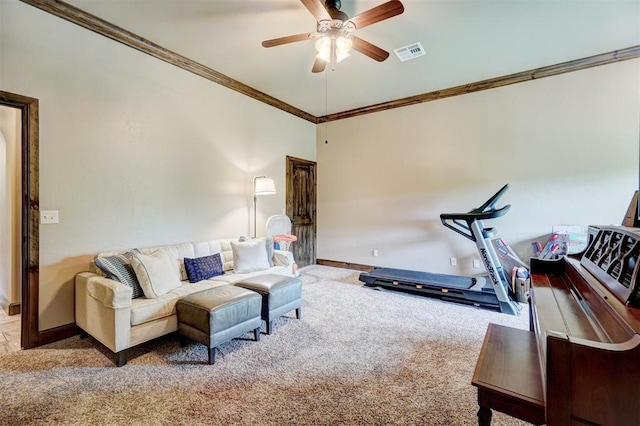 living area featuring visible vents, crown molding, baseboards, ceiling fan, and carpet