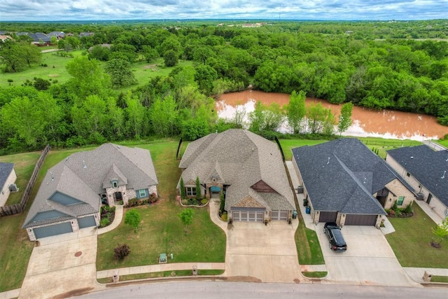 drone / aerial view featuring a residential view and a forest view