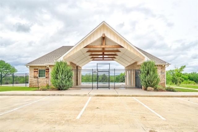 view of building exterior featuring fence and uncovered parking
