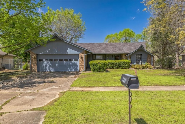 ranch-style house featuring driveway, a front yard, a garage, brick siding, and fence