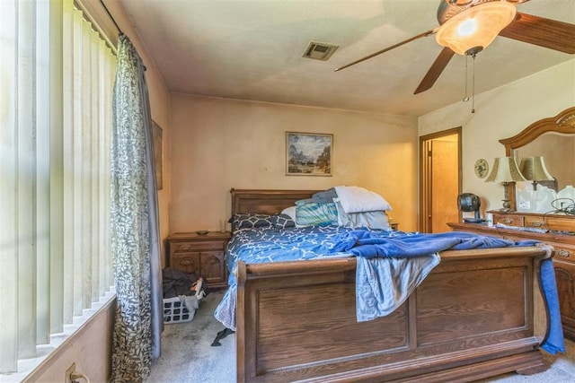 bedroom featuring carpet floors, ceiling fan, and visible vents