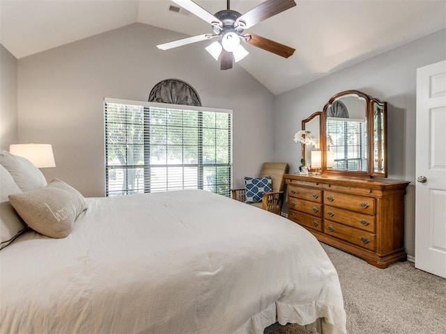 bedroom featuring a ceiling fan, visible vents, light carpet, and lofted ceiling