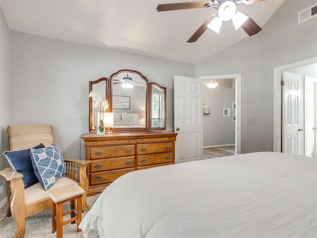 bedroom with ceiling fan, visible vents, baseboards, and vaulted ceiling