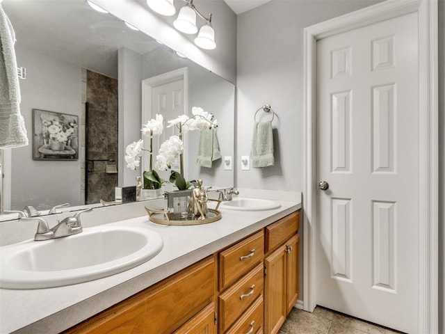 full bathroom featuring double vanity, a sink, and tile patterned flooring